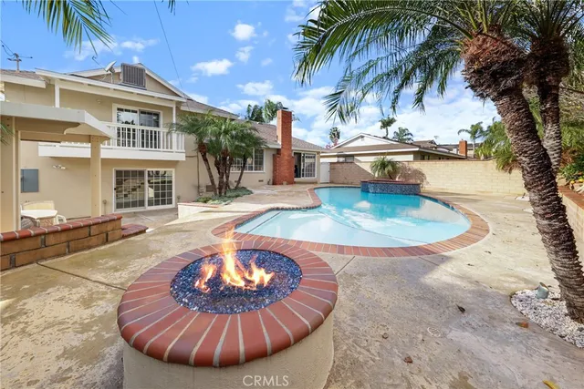a view of a swimming pool with a table and chairs