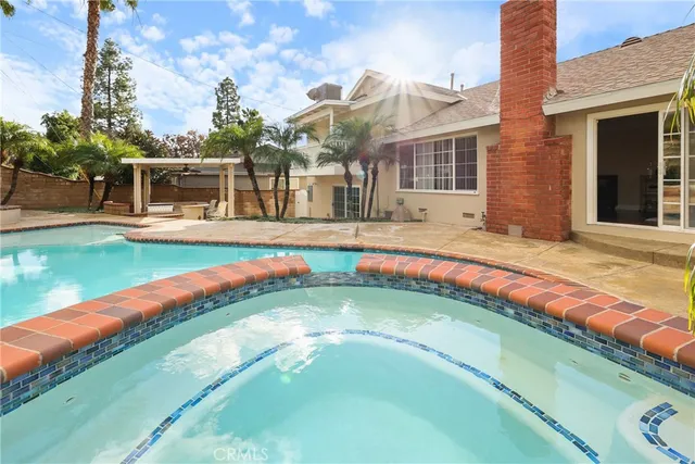 a view of a swimming pool with a red chairs