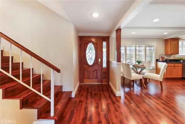 a kitchen with stainless steel appliances granite countertop table chairs sink and cabinets