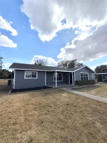a view of a house with wooden fence