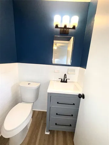 a bathroom with a sink mirror and toilet
