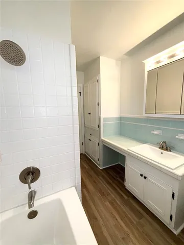 a bathroom with a double vanity sink a mirror and a shower