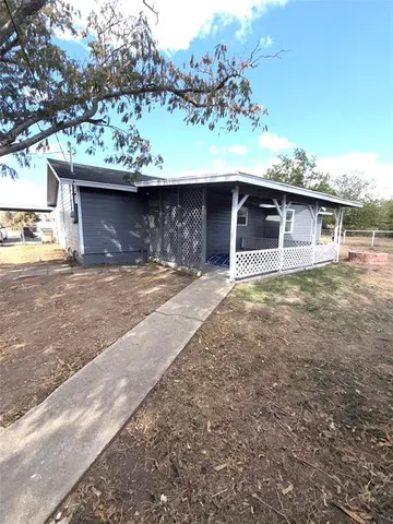 a view of a house with a yard and garage