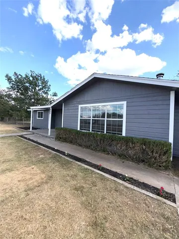 a house with trees in the background