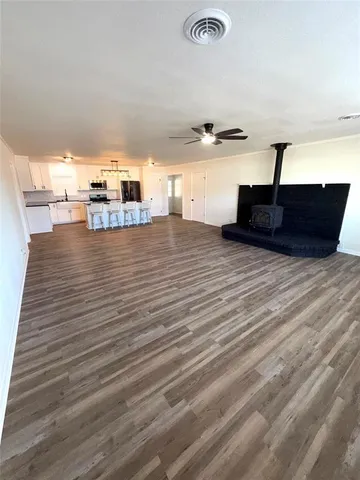 a view of a room with wooden floor