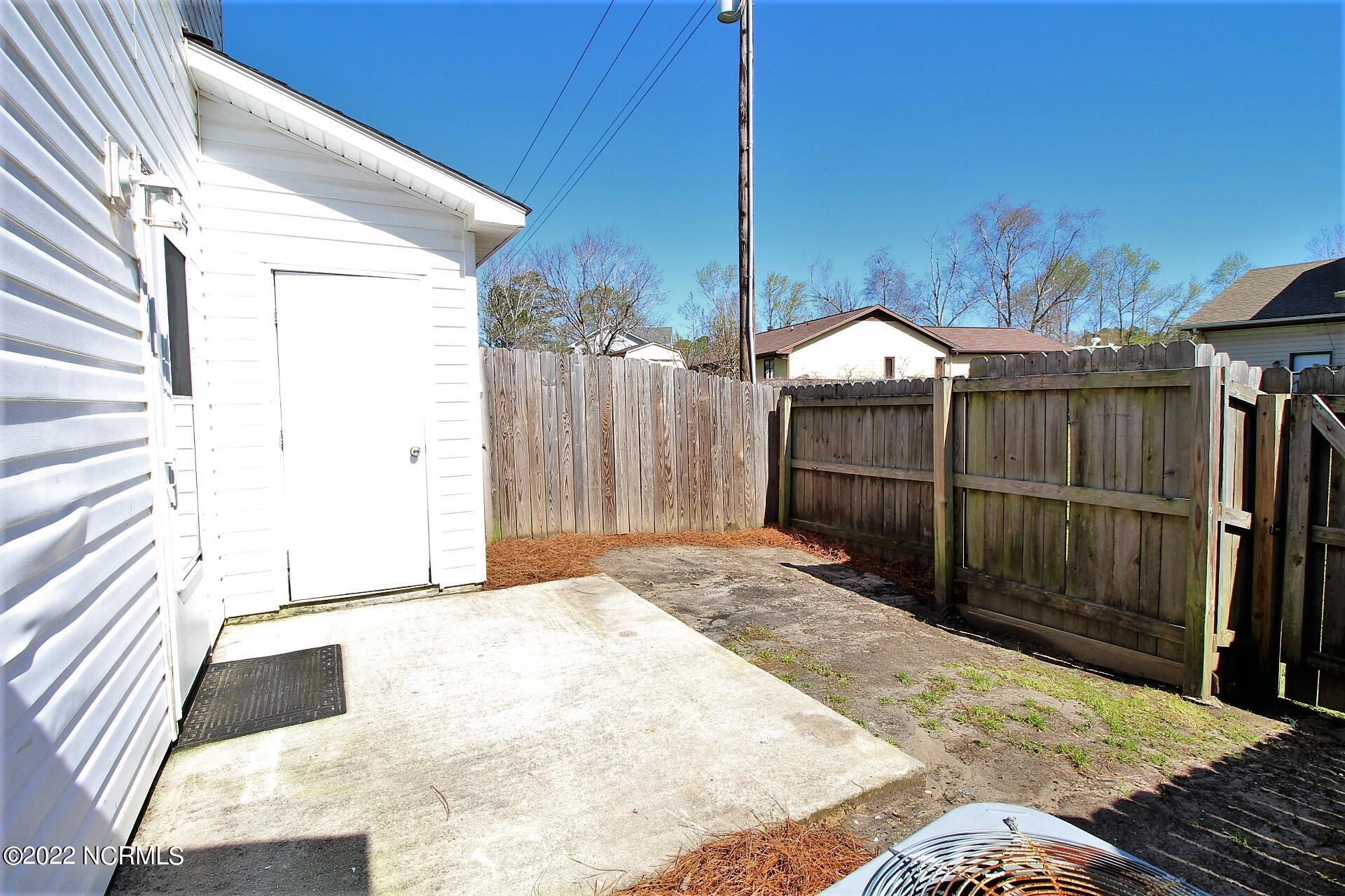 143 Apache Trail Havelock, NC 28532 - Photo 27 of 27 Fenced rear yard with storage room
