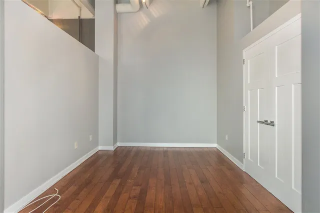 a view of a room with wooden floor