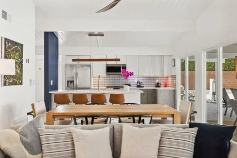 a kitchen with stainless steel appliances kitchen island granite countertop a refrigerator and a stove