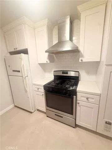 a stove top oven sitting inside of a kitchen