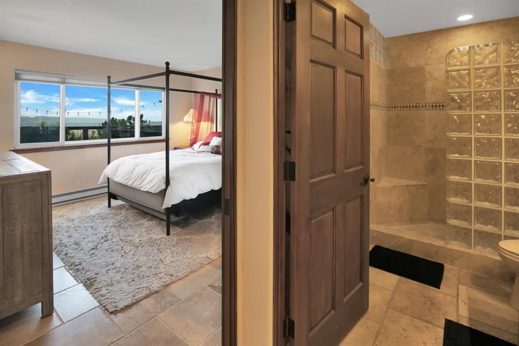 4820 Opal Cliff Drive, Unit 102 Capitola, CA 95010 - Photo 18 of 38 a bedroom with a bed and a window