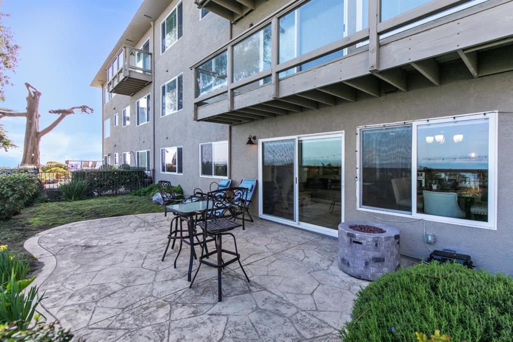 4820 Opal Cliff Drive, Unit 102 Capitola, CA 95010 - Photo 7 of 38 a view of a patio with table and chairs and potted plants
