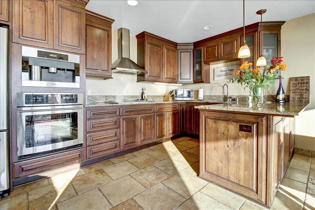 4820 Opal Cliff Drive, Unit 102 Capitola, CA 95010 - Photo 10 of 38 a kitchen with stainless steel appliances granite countertop a stove a sink and a microwave