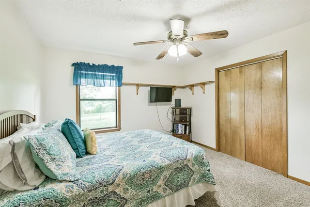 a bedroom with a large bed and a chandelier