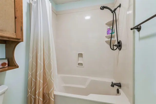 a bathroom with a shower and a tub