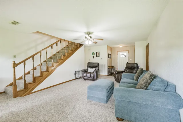 a living room with furniture and a chandelier