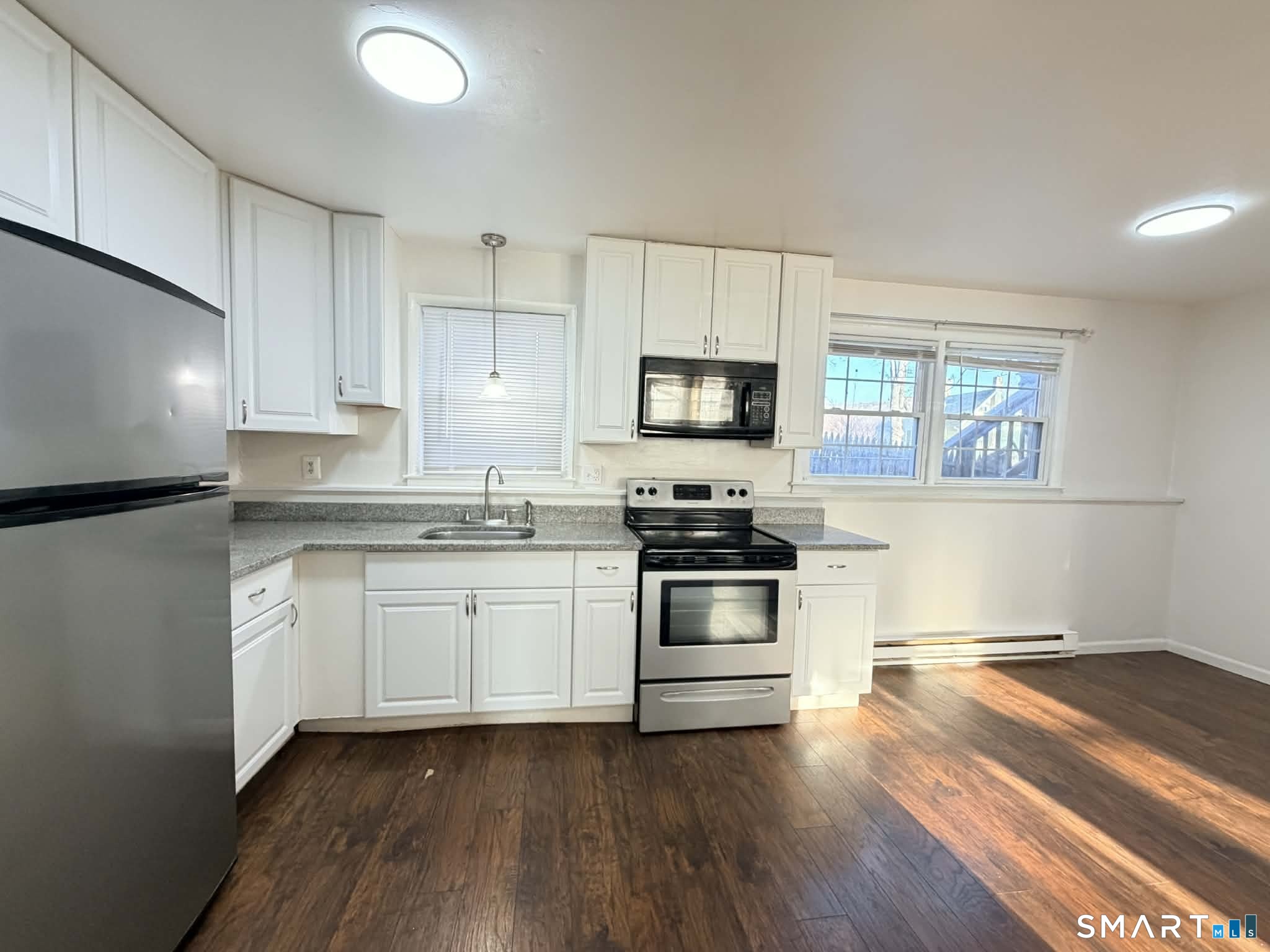 12 Terrace Place, Unit 2 New Milford, CT 06776 - Photo 3 of 11 a kitchen with granite countertop white cabinets and stainless steel appliances