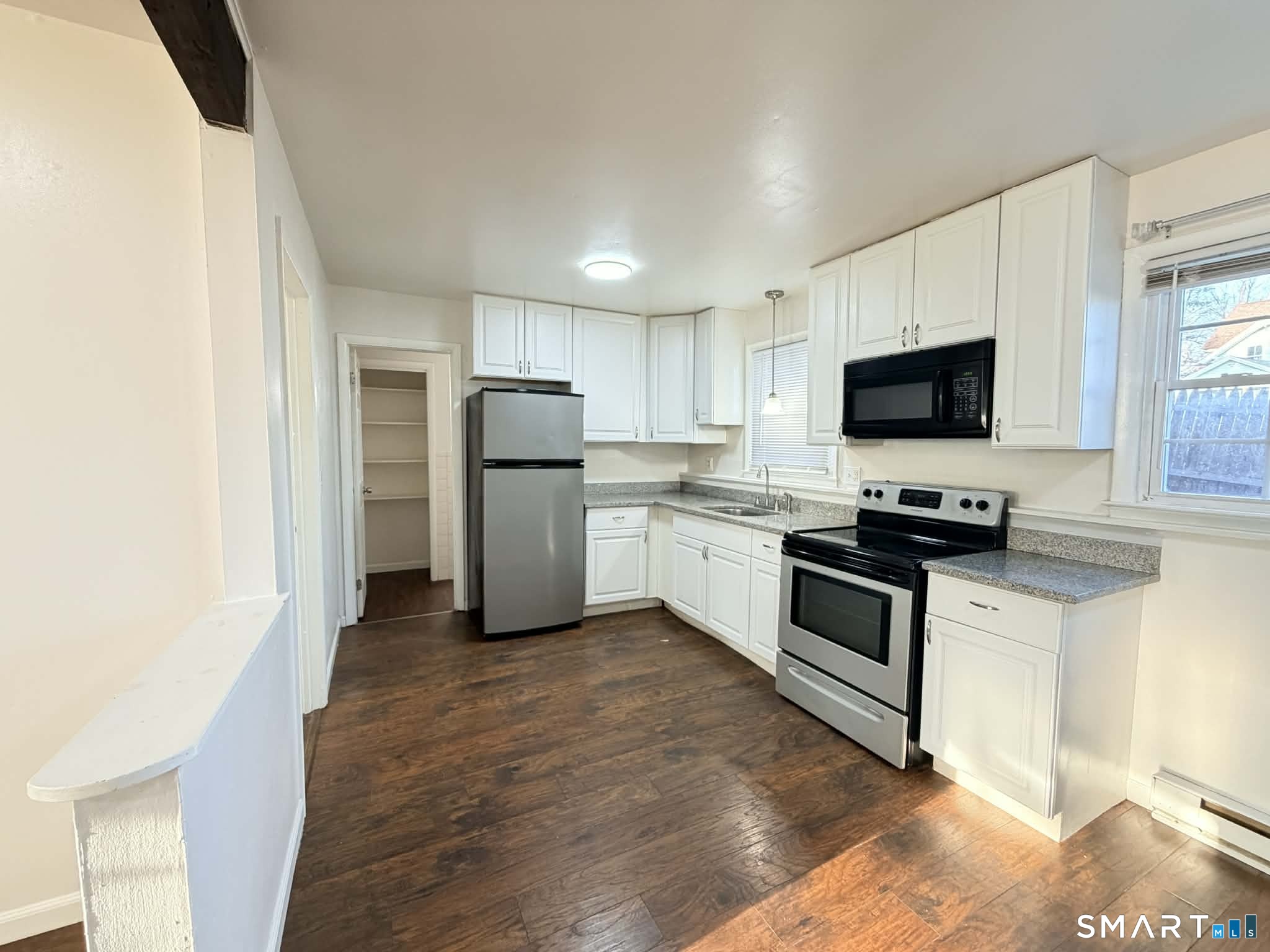 12 Terrace Place, Unit 2 New Milford, CT 06776 - Photo 4 of 11 a kitchen with a sink stainless steel appliances and cabinets