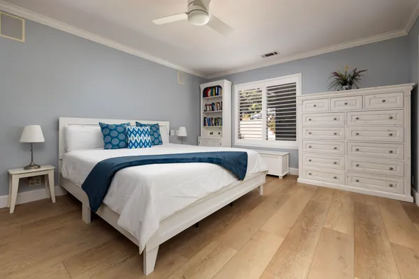 a bedroom with a bed and a dresser