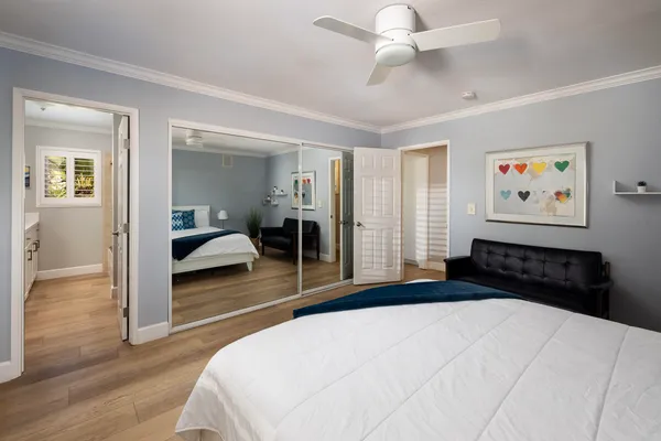 a bedroom with a bed and a chandelier