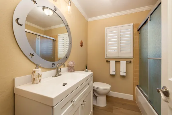 a bathroom with a sink a toilet and a mirror
