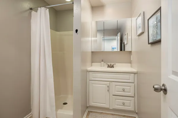 a bathroom with a sink a mirror and a shower