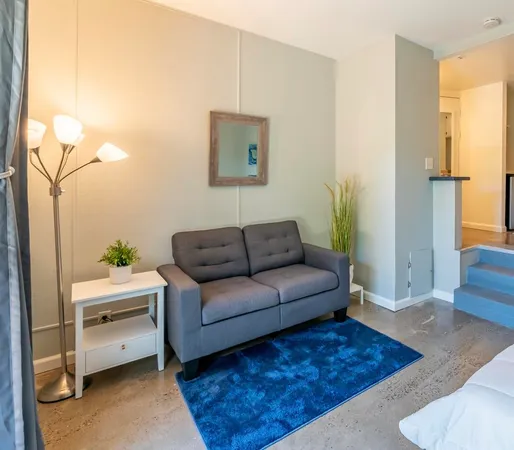 a living room with furniture and a rug