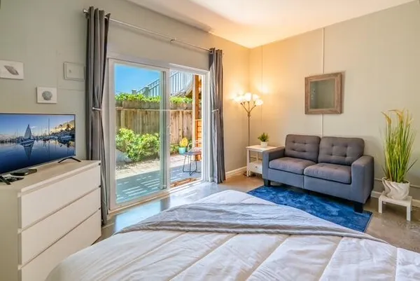 a living room with furniture and a floor to ceiling window