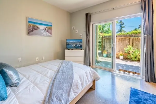 a bedroom with a large bed and a large window