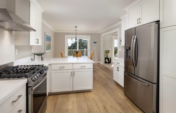 a kitchen with stainless steel appliances a refrigerator stove and sink