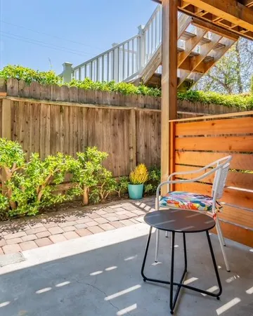 a view of yard from deck with patio