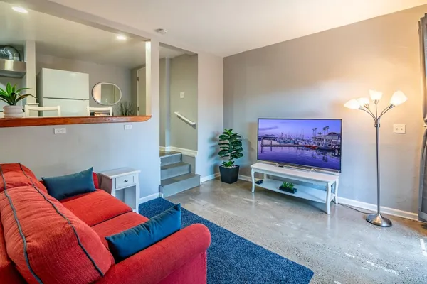 a living room with furniture and a potted plant