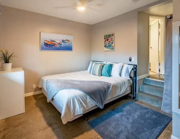 a bedroom with a bed and a couch