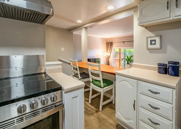 a kitchen with furniture a stove and a refrigerator