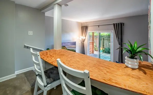 a dining table with a potted plant on it