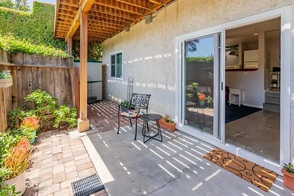 a view of a patio with table and chairs and potted plants