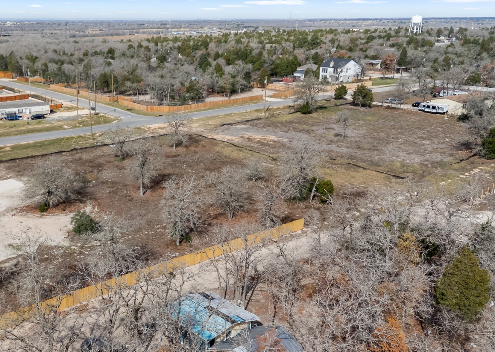 113 Las Alturas Drive Elgin, TX 78621 - Photo 3 of 5 Sprawling undeveloped acreage awaits your vision, bordered by established fencing and mature trees.