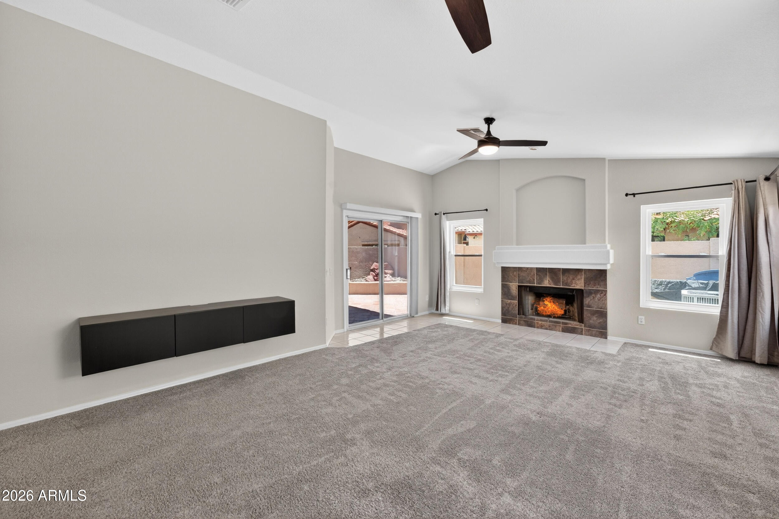 4729 West Monterey Street Chandler, AZ 85226 - Photo 22 of 50 a view of an empty room with chandelier fan and fire place