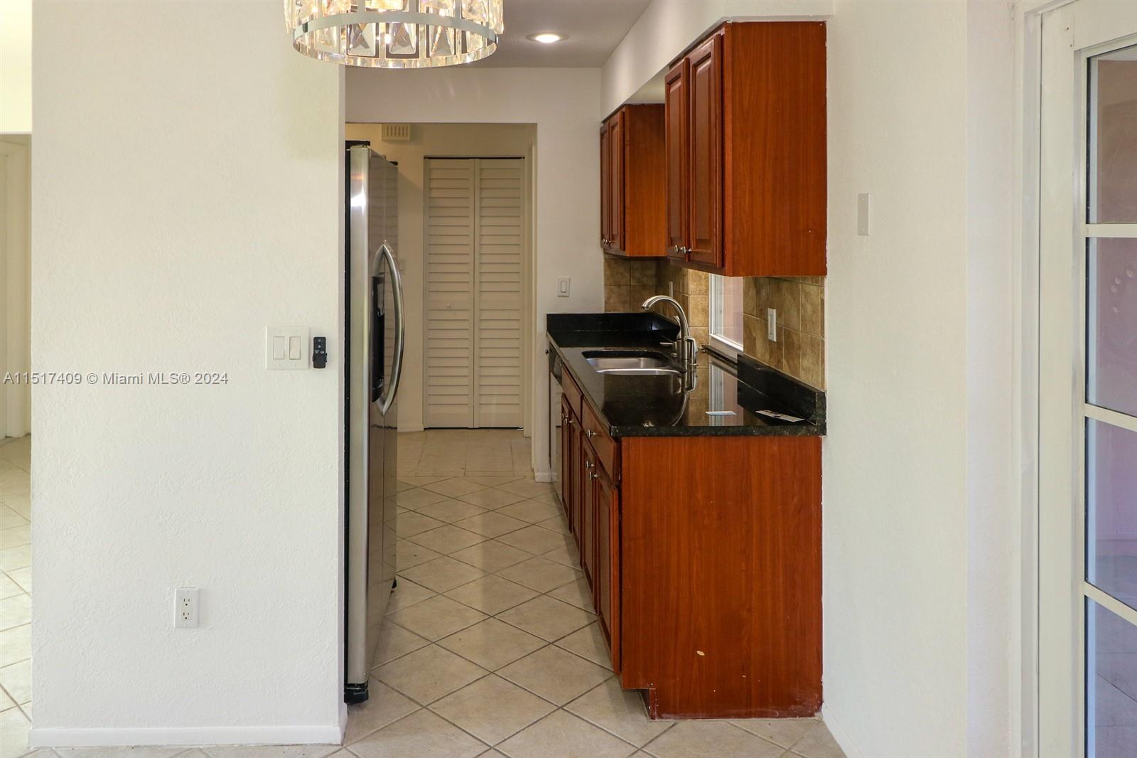 2139 Delta Street Port Charlotte, FL 33952 - Photo 11 of 43 a kitchen with a refrigerator and a stove
