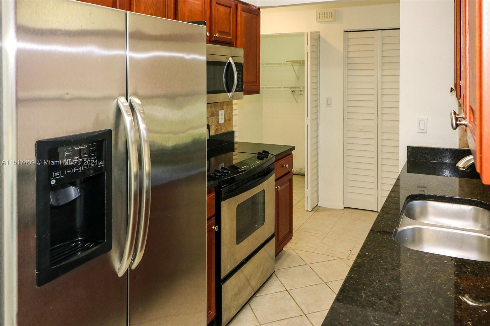 2139 Delta Street Port Charlotte, FL 33952 - Photo 12 of 43 a kitchen with stainless steel appliances granite countertop a refrigerator and a sink