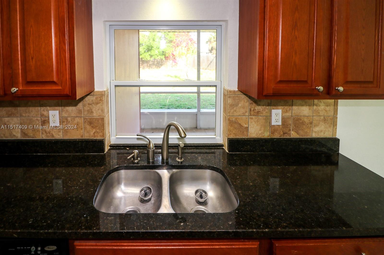 2139 Delta Street Port Charlotte, FL 33952 - Photo 14 of 43 a kitchen with a sink and cabinets