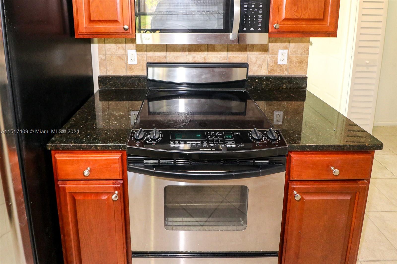 2139 Delta Street Port Charlotte, FL 33952 - Photo 15 of 43 a stove top oven sitting inside of a kitchen