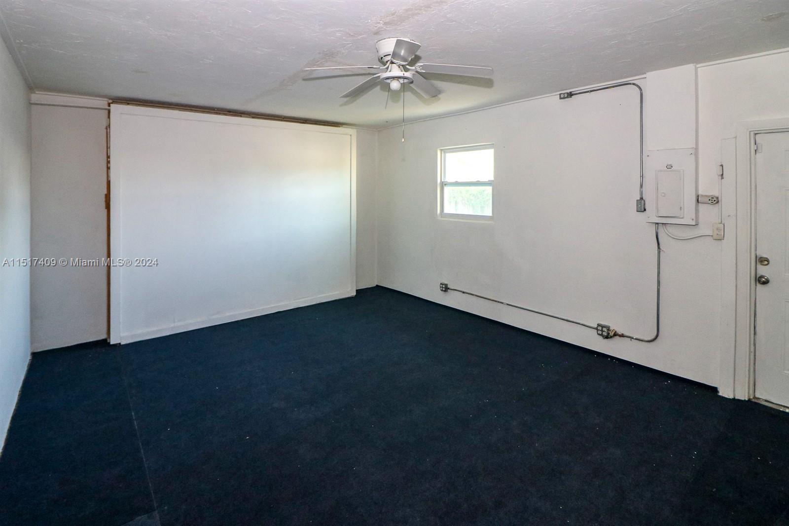 2139 Delta Street Port Charlotte, FL 33952 - Photo 17 of 43 an empty room with a ceiling fan and a window