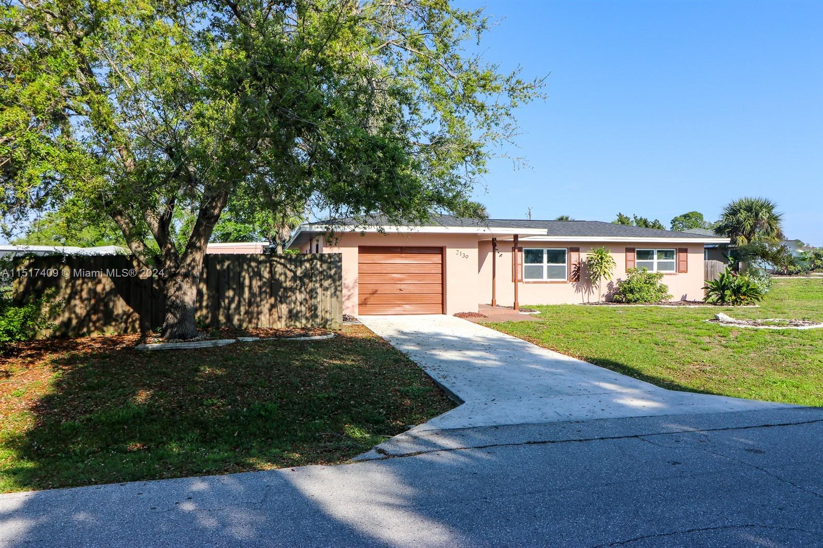 2139 Delta Street Port Charlotte, FL 33952 - Photo 2 of 43 front view of a house with a yard