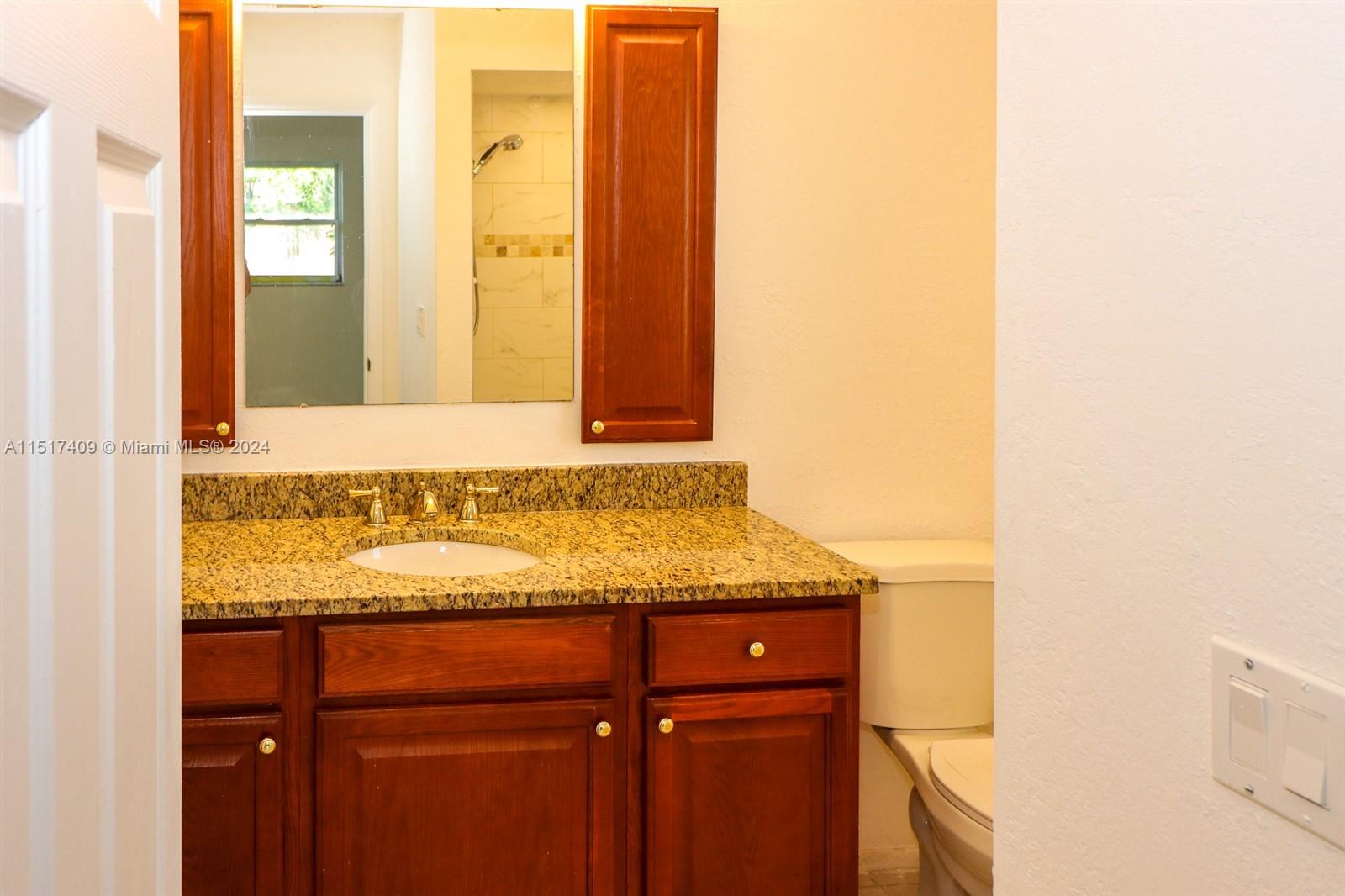 2139 Delta Street Port Charlotte, FL 33952 - Photo 24 of 43 a bathroom with a granite countertop sink and a mirror