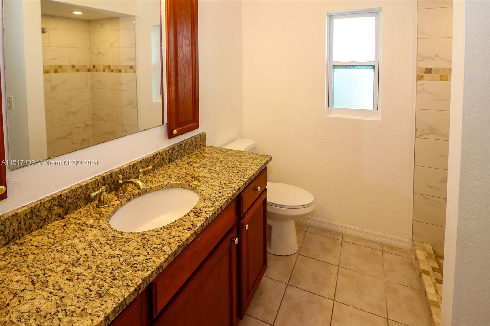 2139 Delta Street Port Charlotte, FL 33952 - Photo 27 of 43 a bathroom with a granite countertop sink and a mirror
