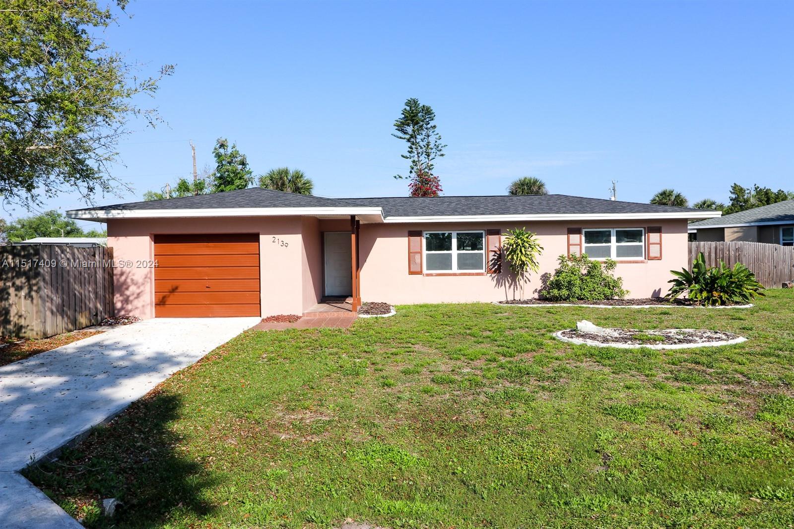 2139 Delta Street Port Charlotte, FL 33952 - Photo 3 of 43 a front view of a house with a yard