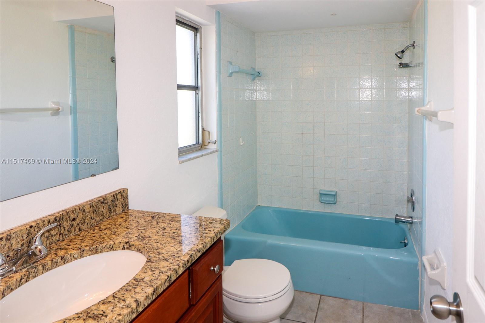 2139 Delta Street Port Charlotte, FL 33952 - Photo 32 of 43 a bathroom with a granite countertop toilet a sink and a bathtub
