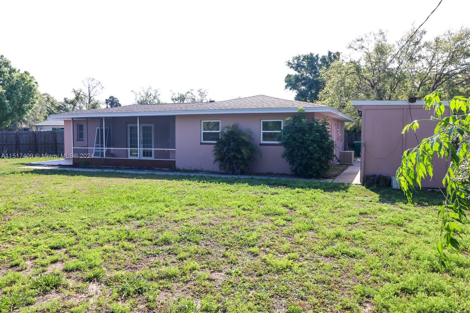 2139 Delta Street Port Charlotte, FL 33952 - Photo 38 of 43 a view of a house with a yard and potted plants