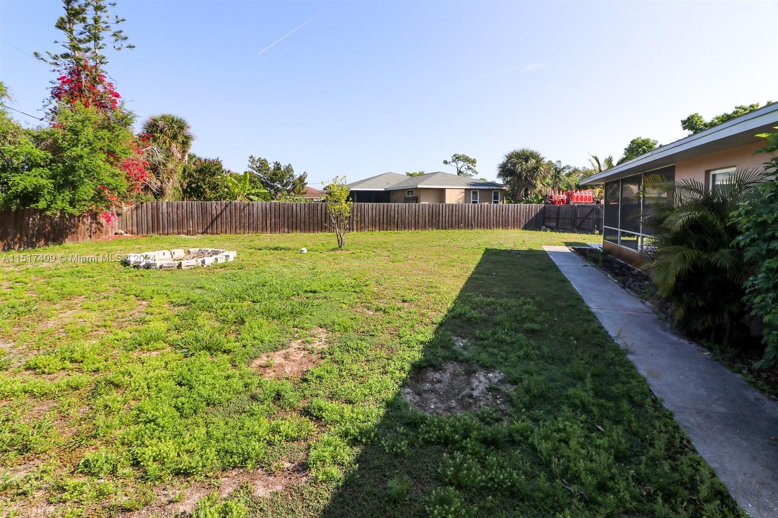 2139 Delta Street Port Charlotte, FL 33952 - Photo 39 of 43 a view of yard with swimming pool and green space