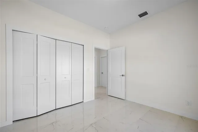 a view of an empty room and a window